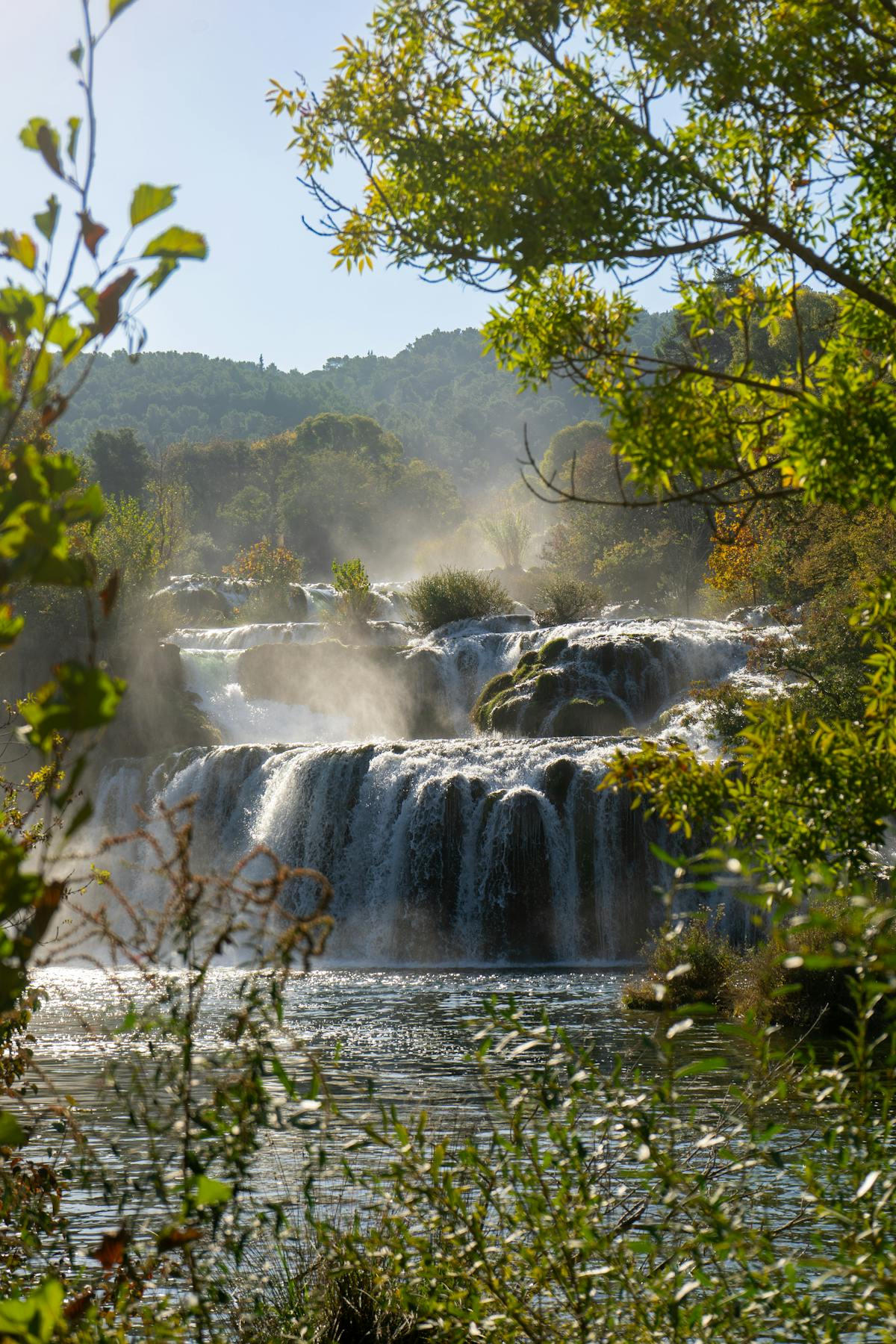Cascading waterfalls with lush greenery in national park