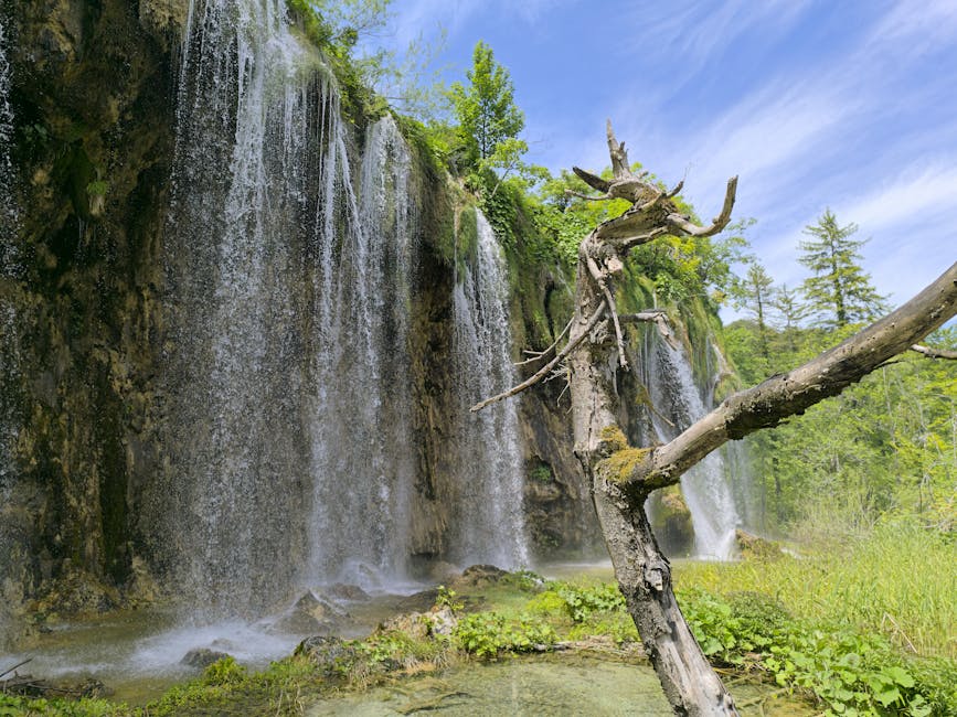 Plitvice waterfall over rocks lush greenery