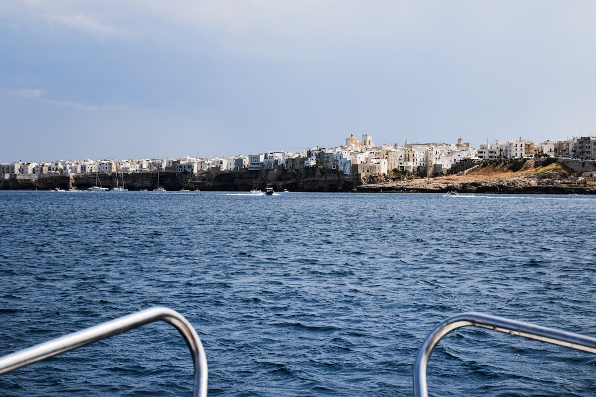 Polignano a Mare seen from a boat on the Adriatic Sea showing cliffs and old town