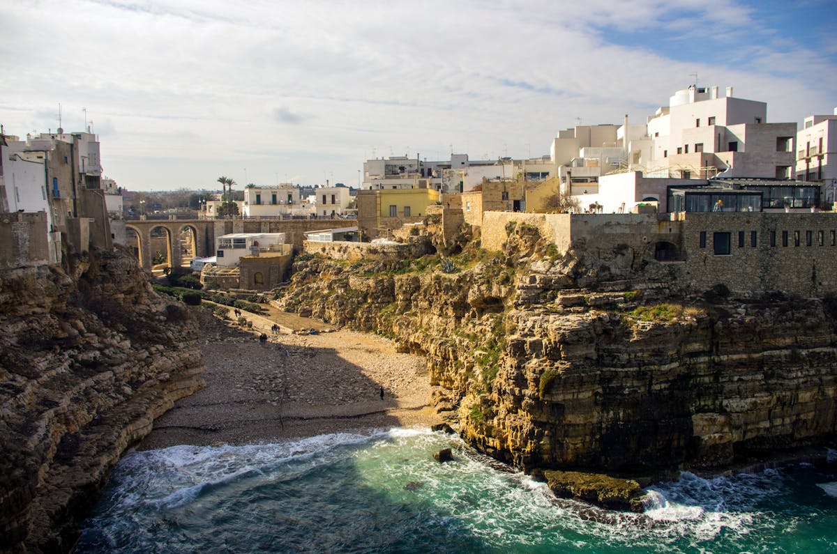 A charming narrow street in the old town of Polignano a Mare with balconies and historic buildings