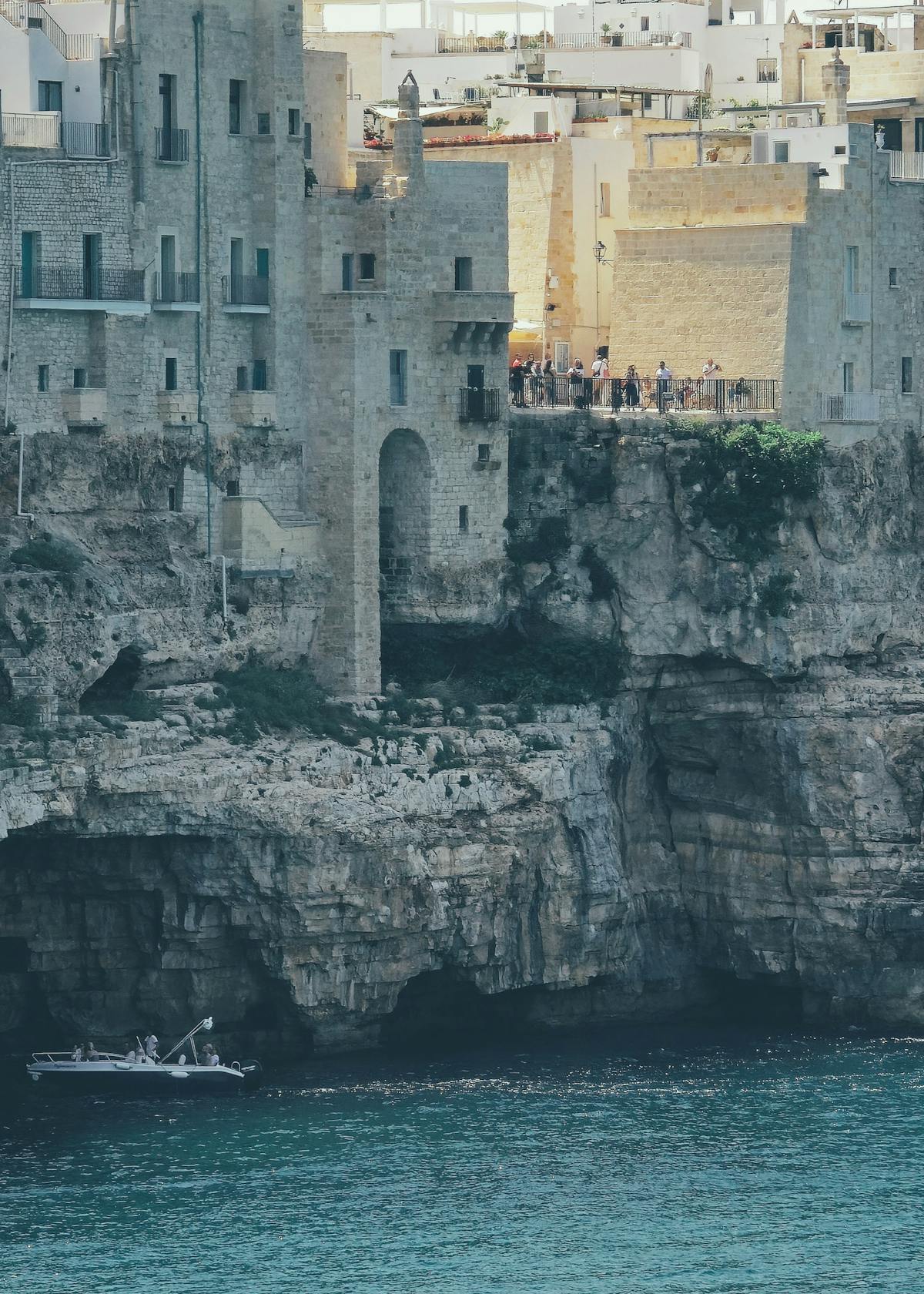 A scenic view of Polignano a Mare cliffside town overlooking crystal blue waters