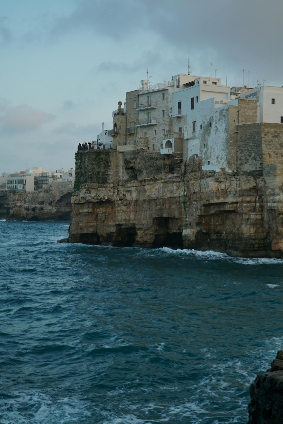 The Italian village of Polignano a Mare sitting on dramatic cliffs above the sea