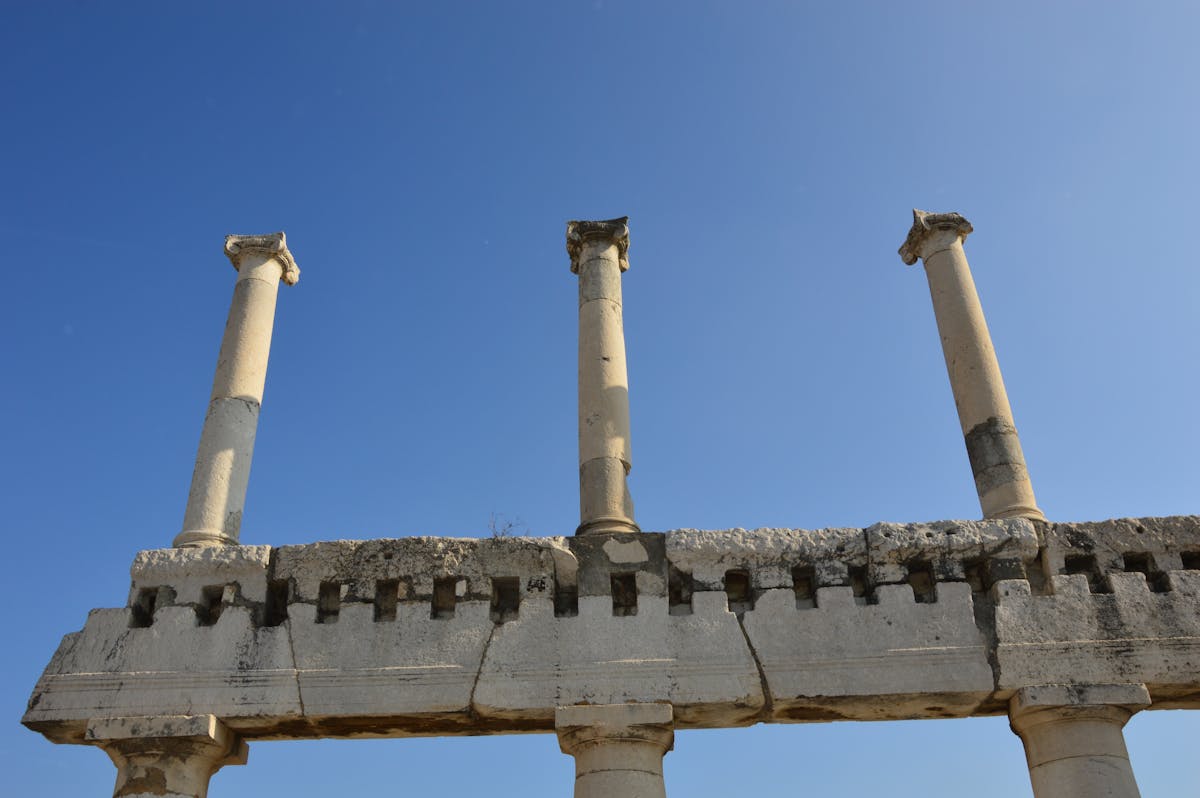 Ancient Roman columns at Pompeii under a clear blue sky