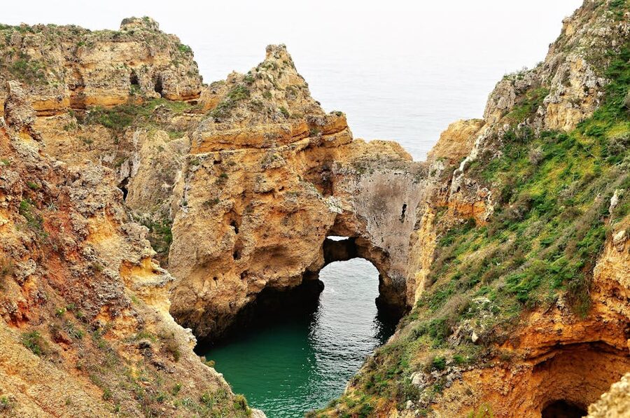Natural rock arch on Algarve coast accessible by boat