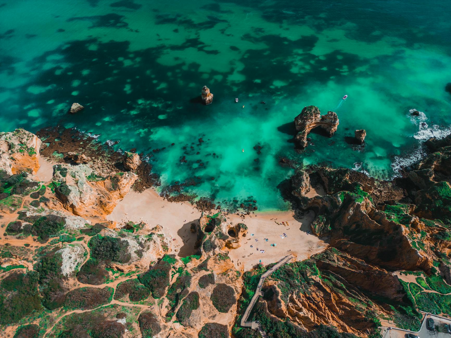 Turquoise coastal waters and rock formations along the Lagos Algarve coastline