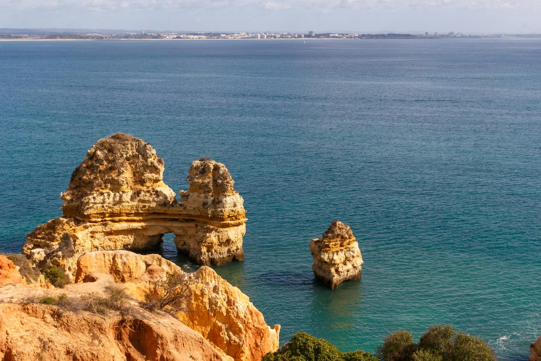 Rock formations and clear turquoise water at Praia do Camilo near Ponta da Piedade in Lagos Portugal