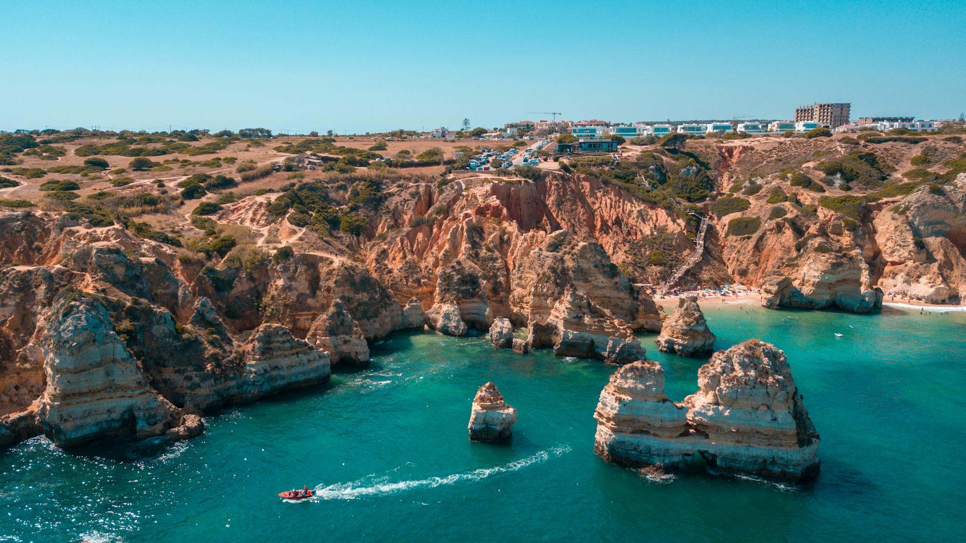 Aerial view of the dramatic rocky coastline and turquoise waters near Lagos in the Algarve region