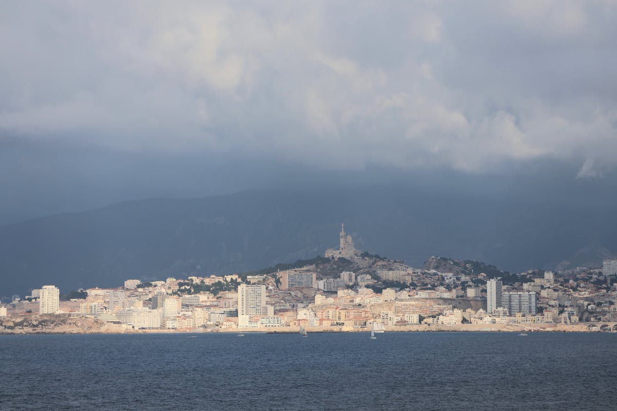 Panoramic view of Marseille city from a hilltop showing harbour and buildings