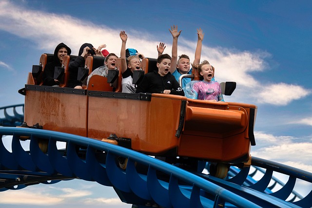 Fast roller coaster with riders at amusement park