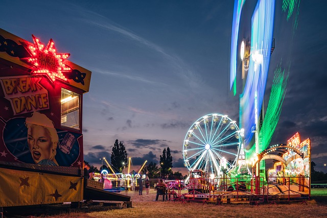 Colorful amusement park lit up at night with ferris wheel and rides
