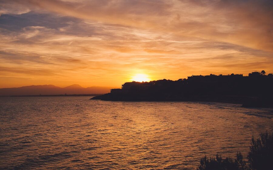 Mountain silhouette and sea at sunset along Salou coastline