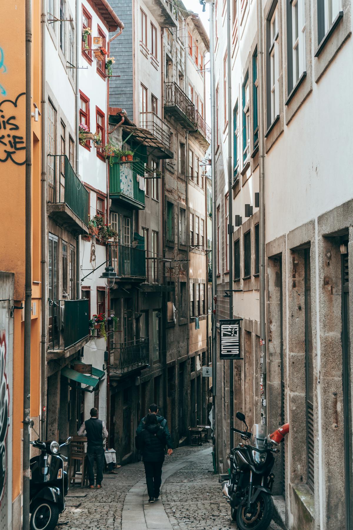Alleyway in Porto with historic buildings and charming balconies