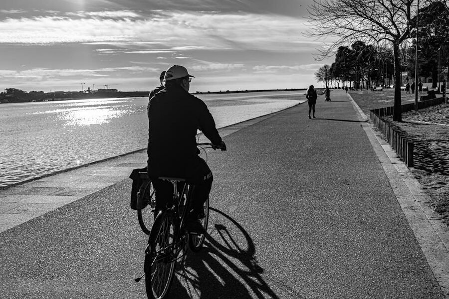 Cyclist on river promenade Porto black and white