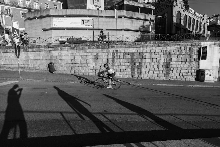 Cyclist long shadow Porto urban street