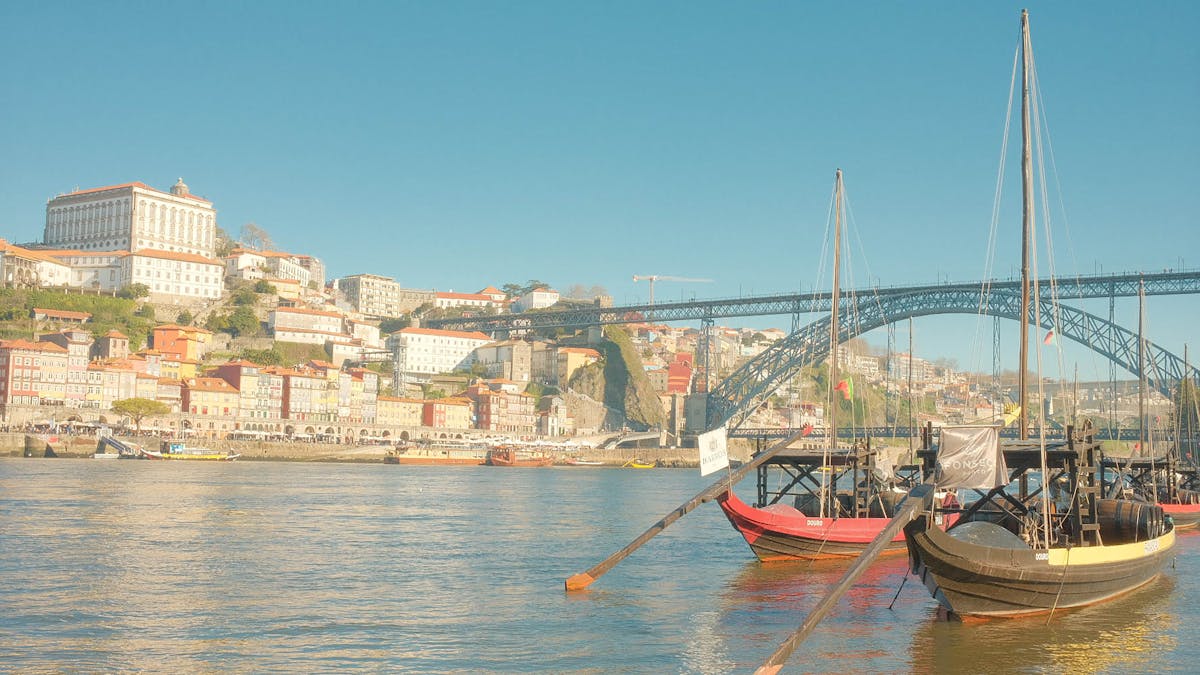 Traditional rabelo boats on the Douro River with colorful Porto buildings