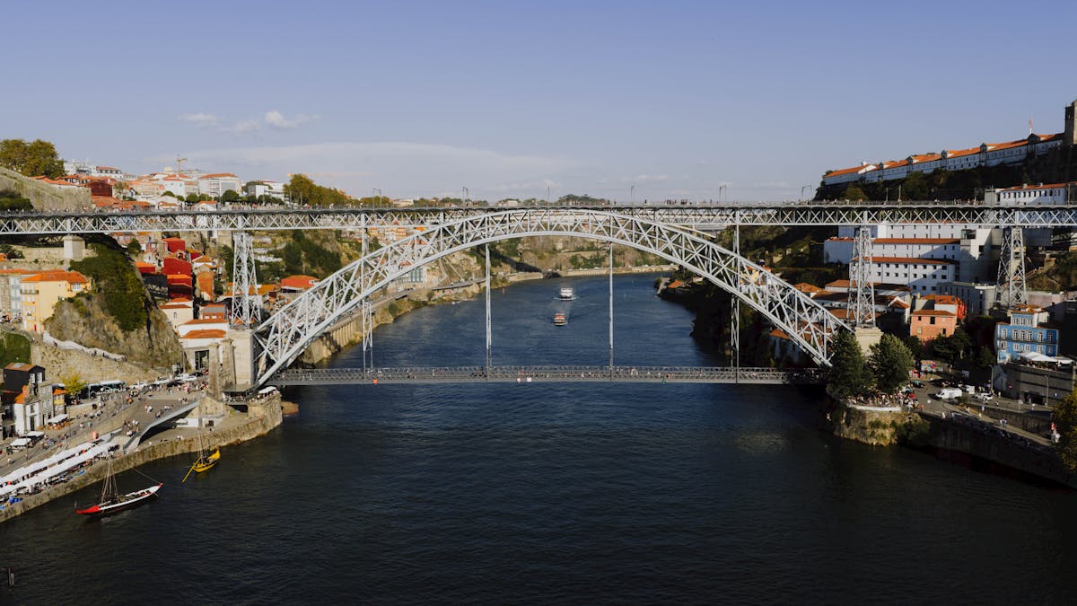 Dom Luis I Bridge arching over the Douro River in Porto under blue skies