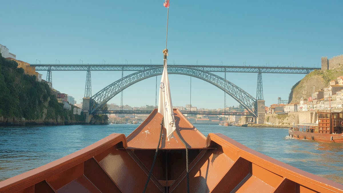View looking up at Dom Luis I Bridge from a boat on the Douro River
