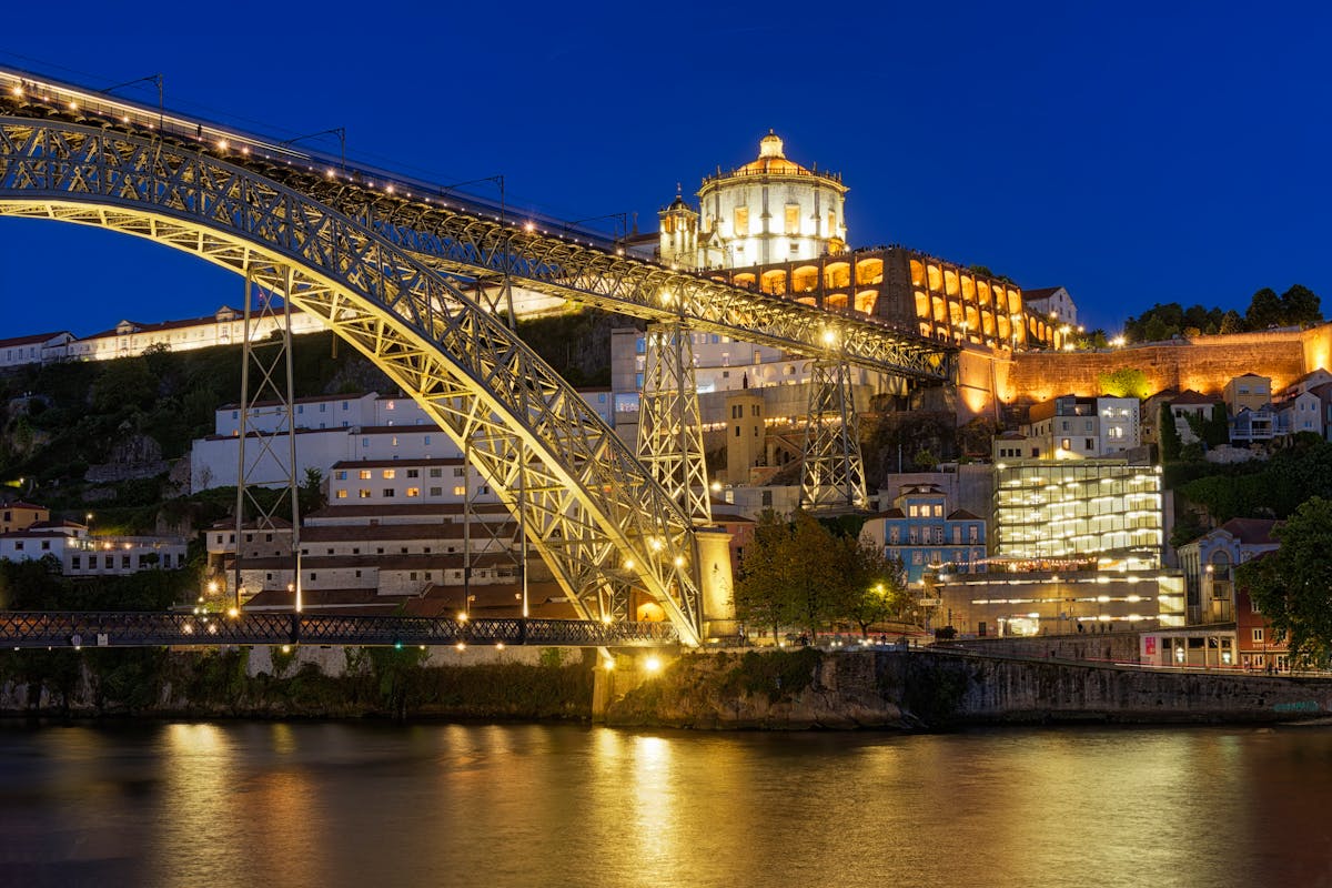 Dom Luis I Bridge and Serra do Pilar Monastery lit up at night in Porto