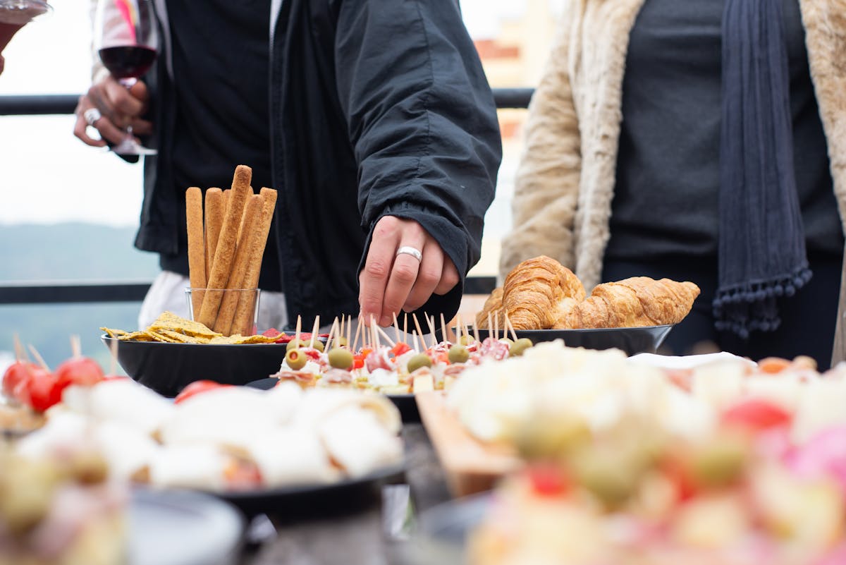 People sharing appetizers at an outdoor meal in Portugal