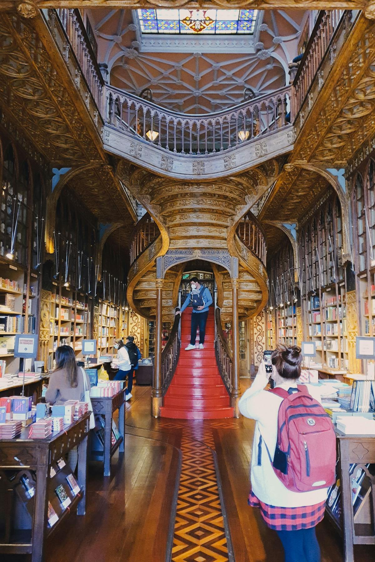 Interior of the Livraria Lello bookstore in Porto featuring the iconic red staircase