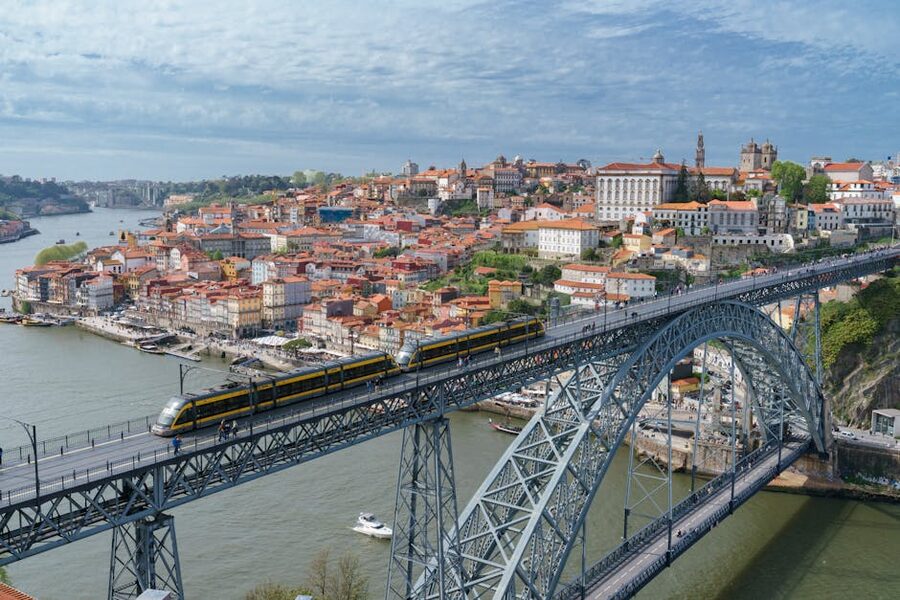 Metro train crossing Luis I Bridge upper deck in Porto