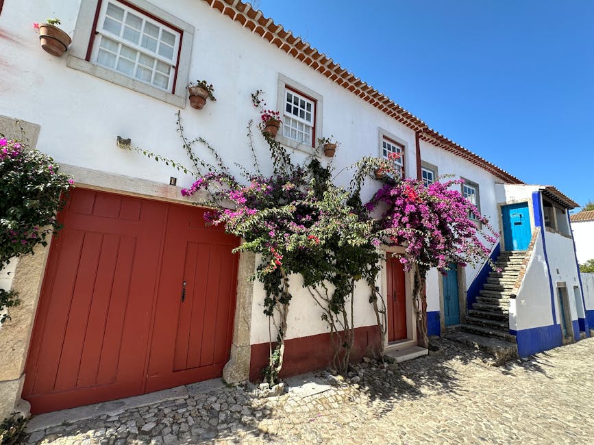 Picturesque Obidos street with bougainvillea and rustic architecture