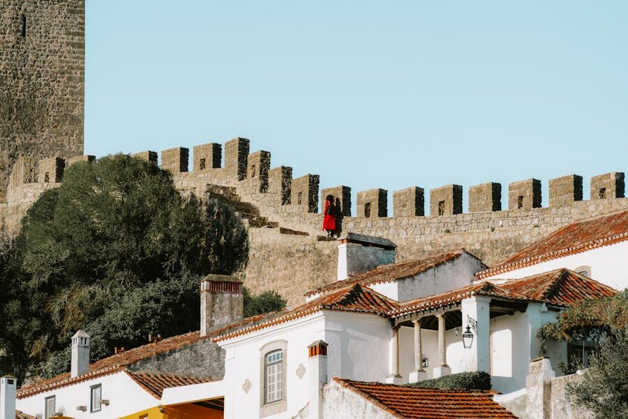 Obidos historic walls and whitewashed buildings under summer sky