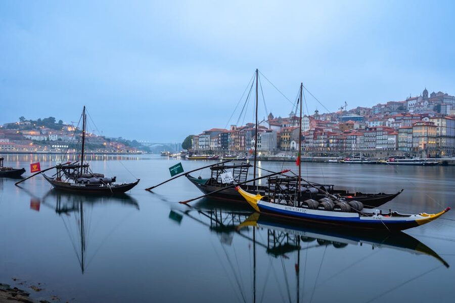 Porto rabelo boats reflecting on the Douro at twilight