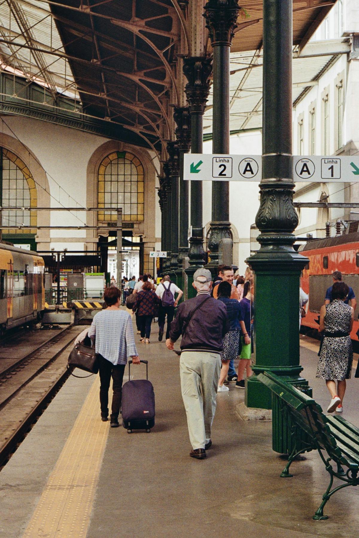 Passengers walking through the elegant interior of Sao Bento train station in Porto