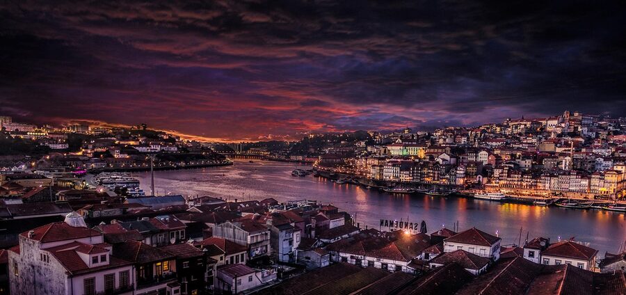 Clérigos Tower lit up over Porto at night