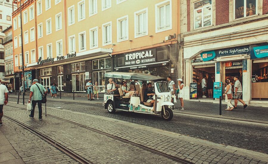Tuk-tuk making its way down a busy Porto street
