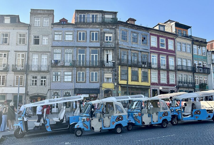 Tuk-tuks in a waiting area by the Porto riverside