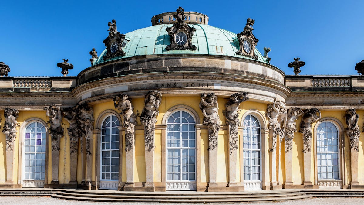 Exterior of Sanssouci Palace showcasing baroque architecture and sculptures