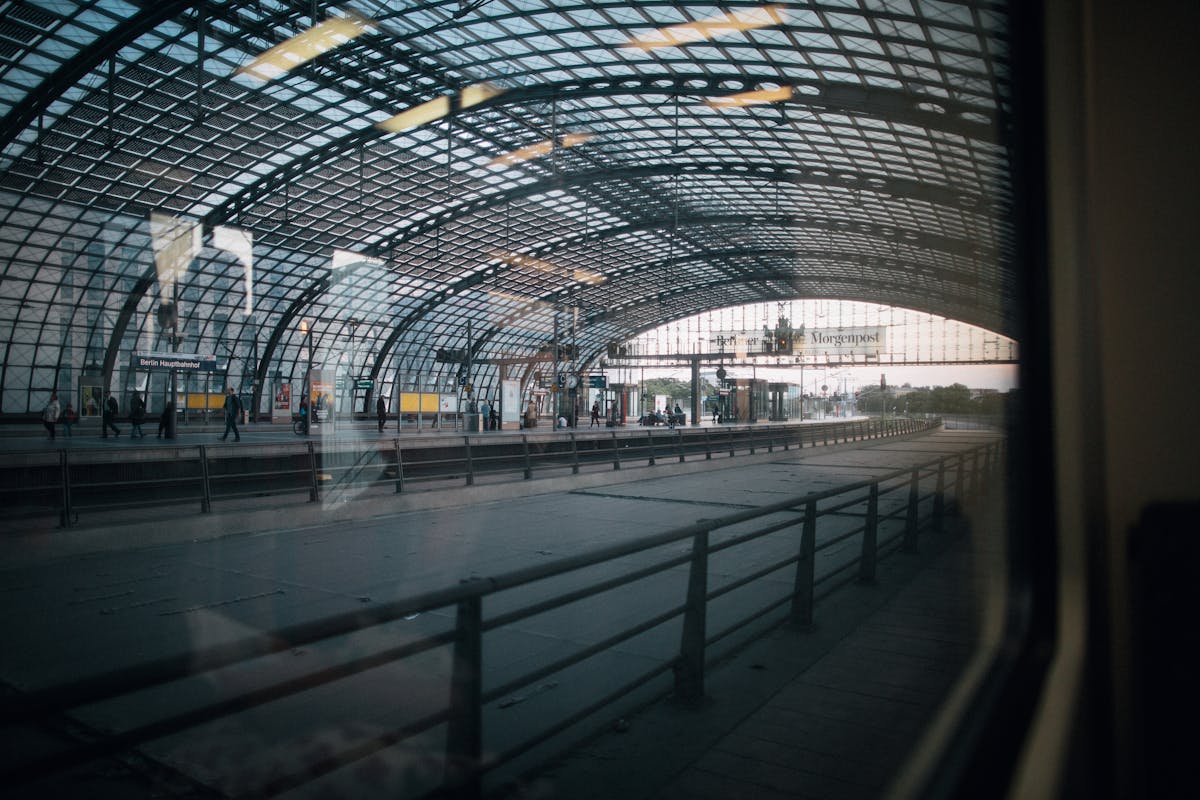 Interior of Berlin Hauptbahnhof with arched glass ceiling and platforms