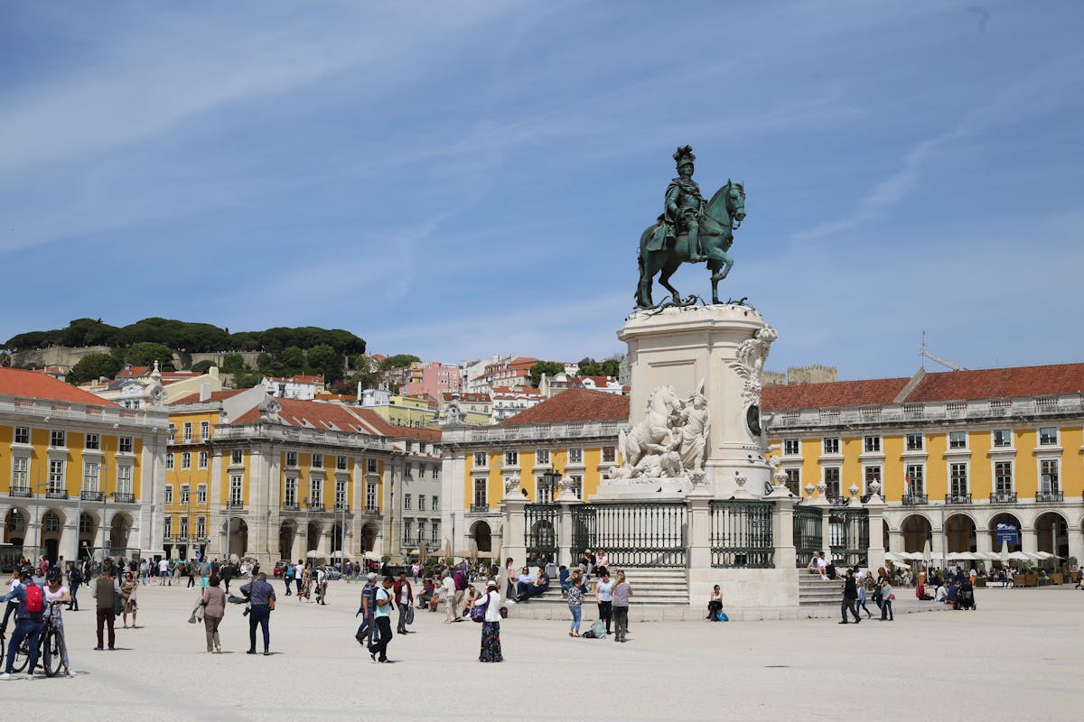 People enjoying a sunny day at the Praca do Comercio square in Lisbon
