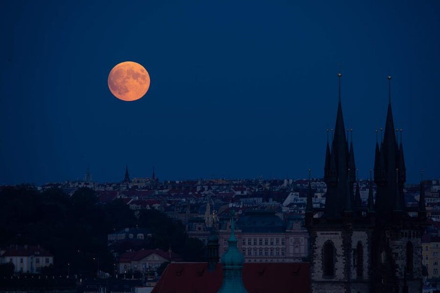 Blood moon over Prague skyline