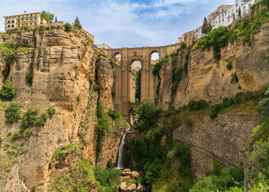 Puente Nuevo bridge with surrounding green valley Ronda