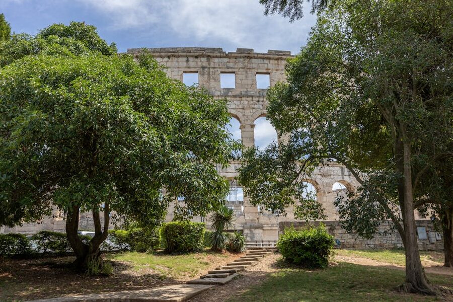 Roman amphitheater Pula framed by trees