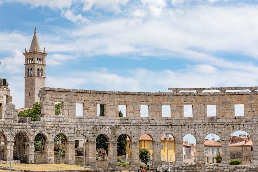 Pula Arena with bell tower Croatia sunny day
