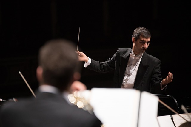 An orchestra conductor leading a symphony performance