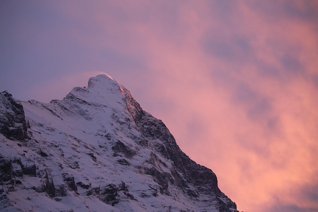 The Eiger North Face glowing orange and red at sunset in the Swiss Alps