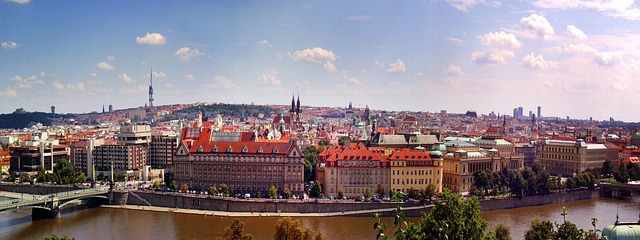 Panoramic view of Prague skyline with medieval church spires and red rooftops