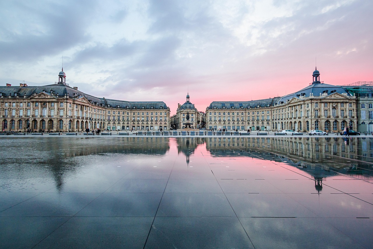 Place de la Bourse in Bordeaux at sunset with golden sky