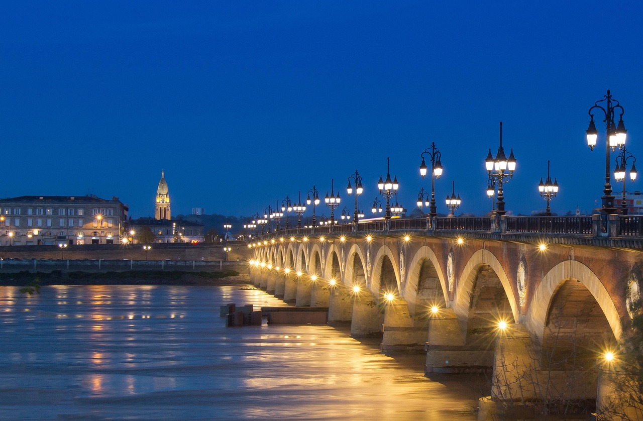 Stone bridge in Bordeaux at blue hour with Napoleon coat of arms detail