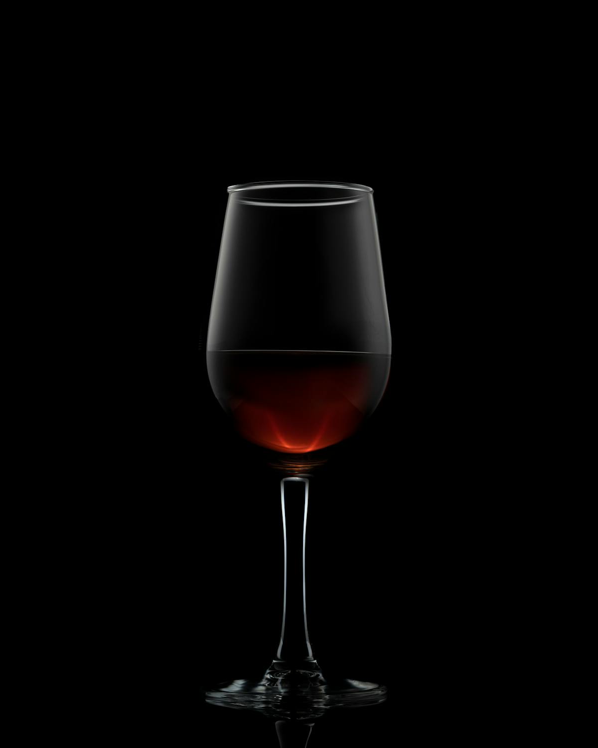 Glass of red wine on dark backdrop