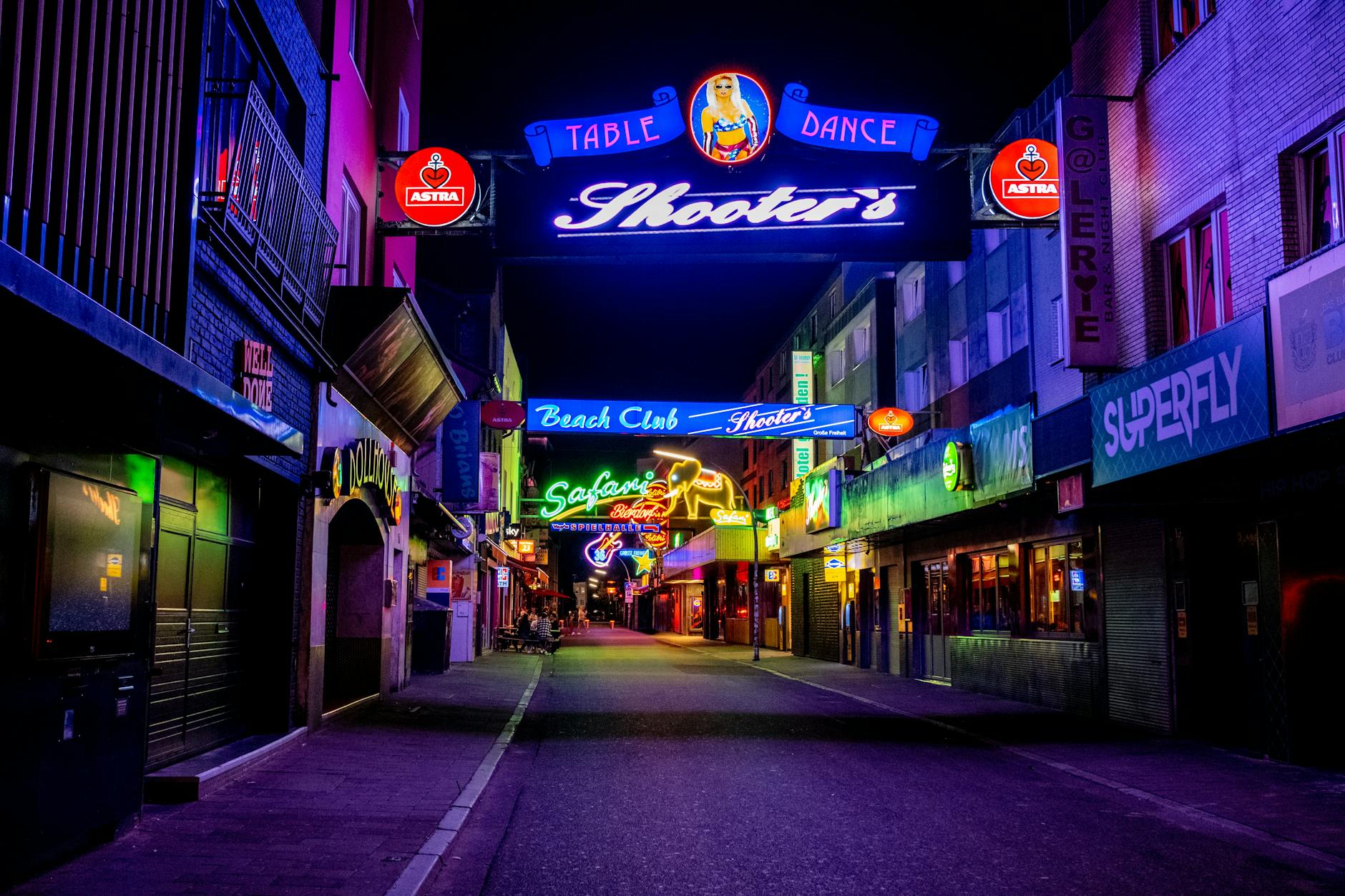 Neon-lit Reeperbahn street at night in Hamburg St Pauli district