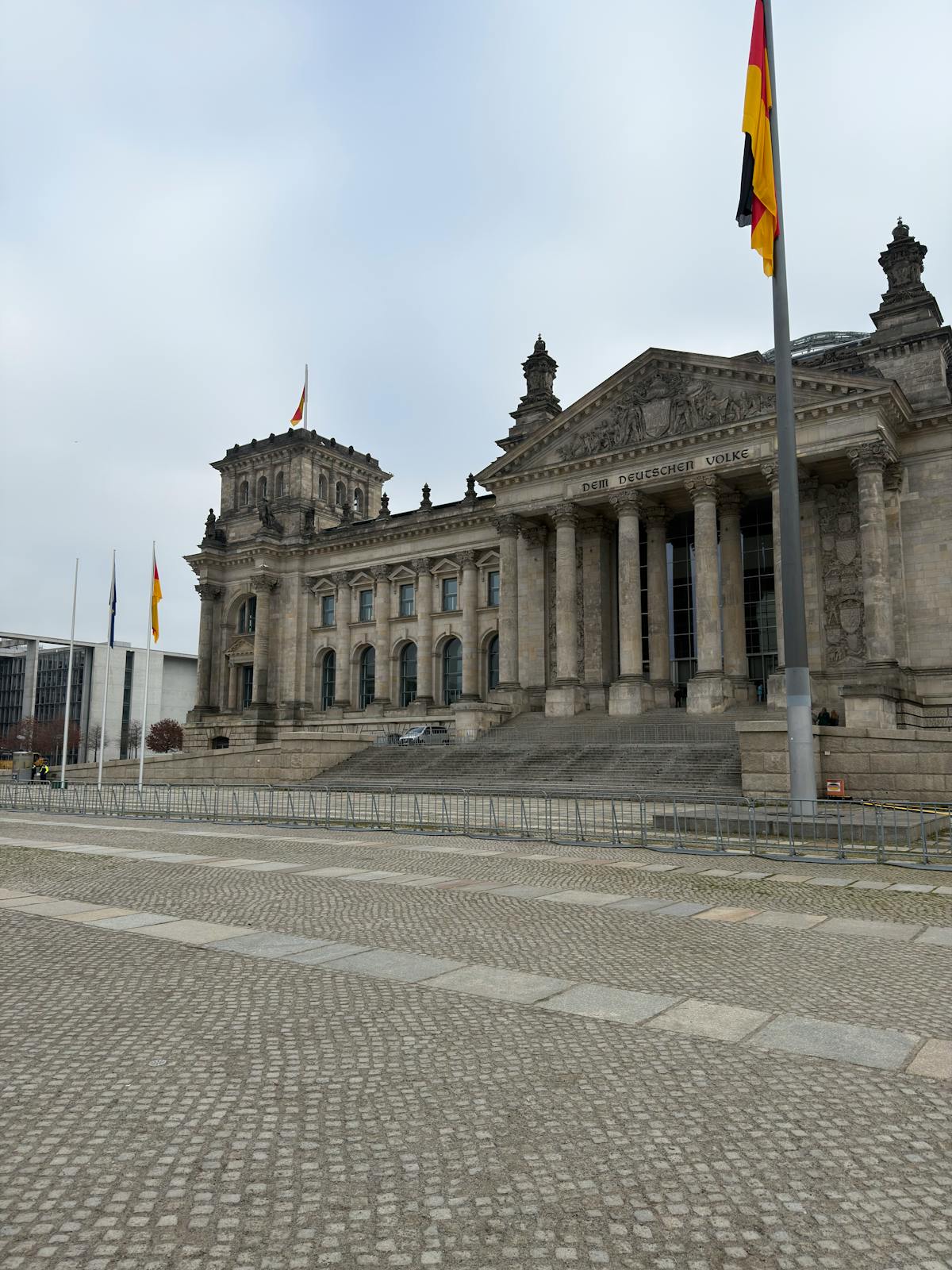 German flags waving in front of the Reichstag building