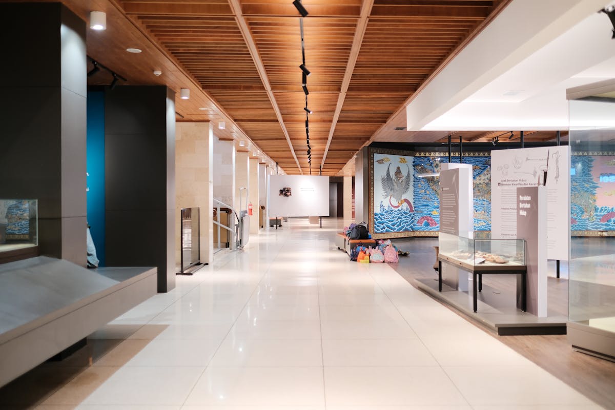 Bright museum hallway with exhibits and empty walkways showcasing modern design