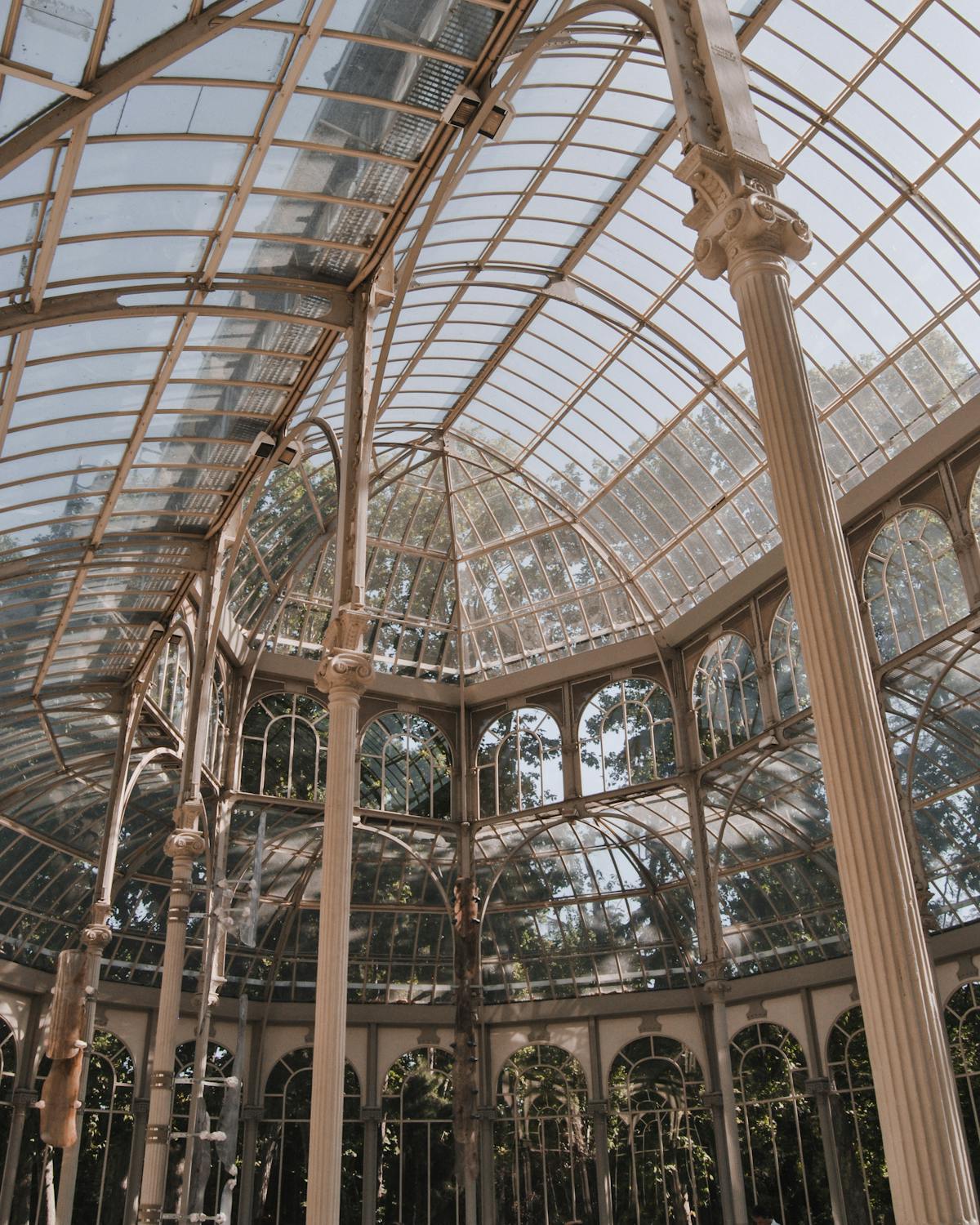 Stunning interior view of Palacio de Cristal in Retiro Park Madrid showing glass architecture