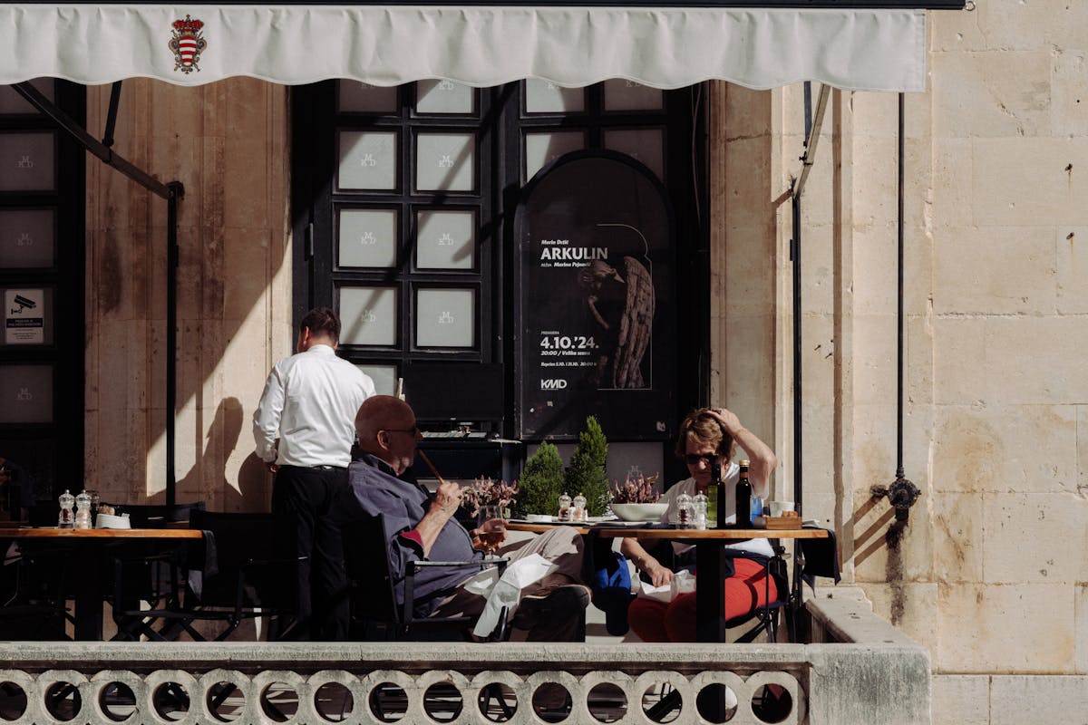 People at outdoor cafe in Dubrovnik on a sunny day